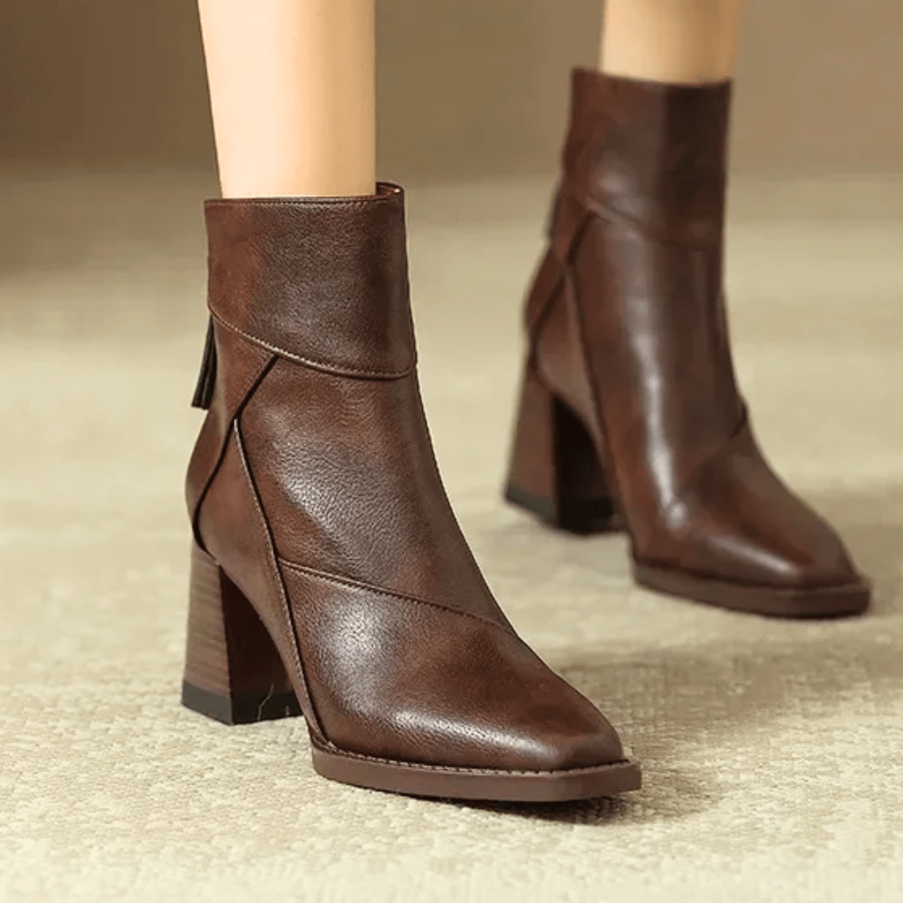 Pair of brown ankle-fit block heel boots with pointed toe and side zipper