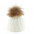 Knit beanie hat with tan pom-pom, ribbed texture, white color