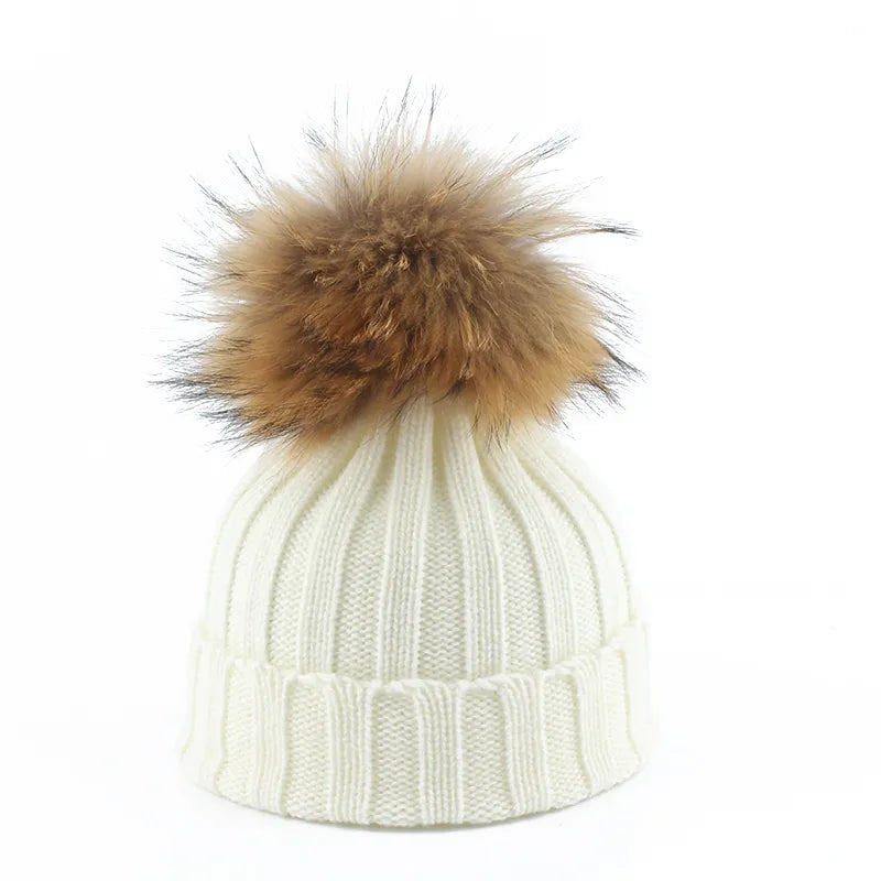 Knit beanie hat with tan pom-pom, ribbed texture, white color