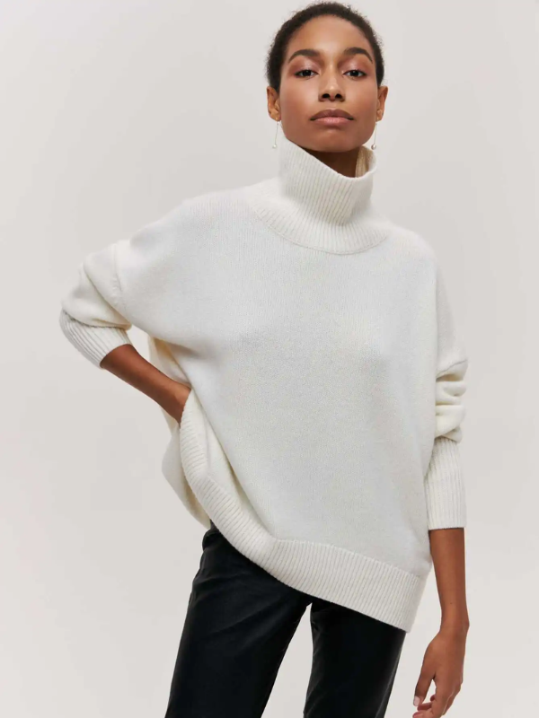 White knitted turtleneck sweater with long sleeves and ribbed collar