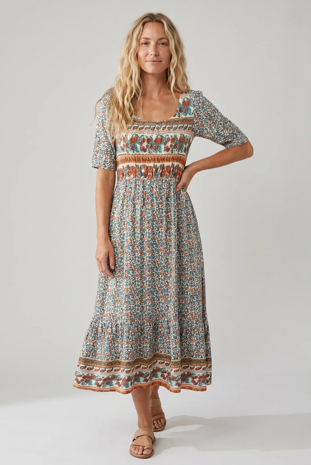 Women's boho print midi dress with shirred bodice, teal floral pattern, tiered skirt