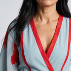 Floral wrap maxi dress neckline: red trim V-neck on light blue fabric