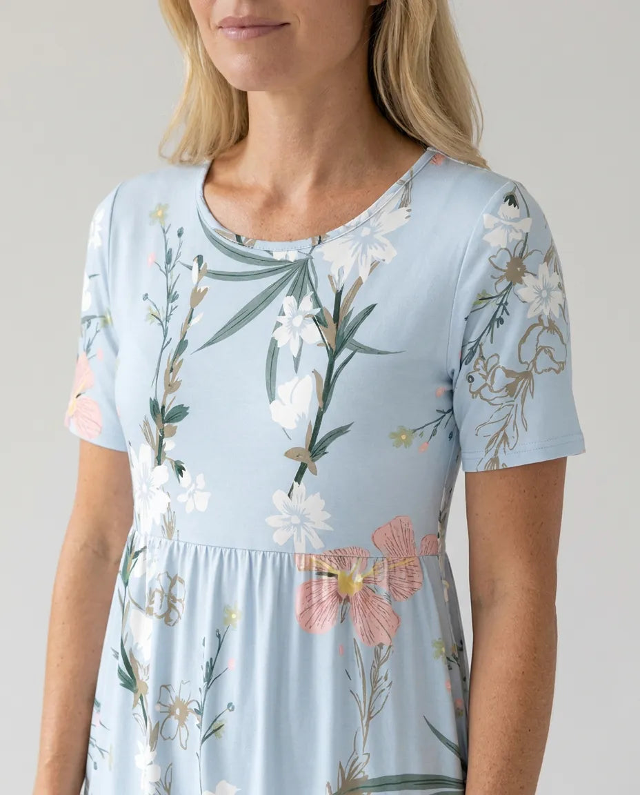 Light blue floral midi dress close-up: short sleeves, scoop neckline, gathered waist.