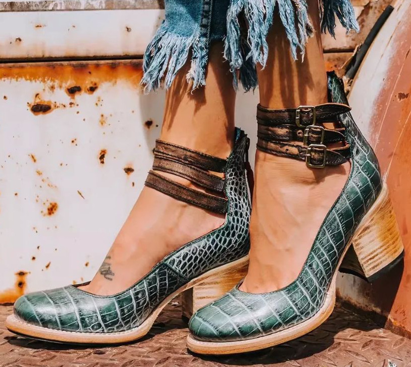 Green snake-embossed leather ankle-strap shoes with buckle straps and block heel.