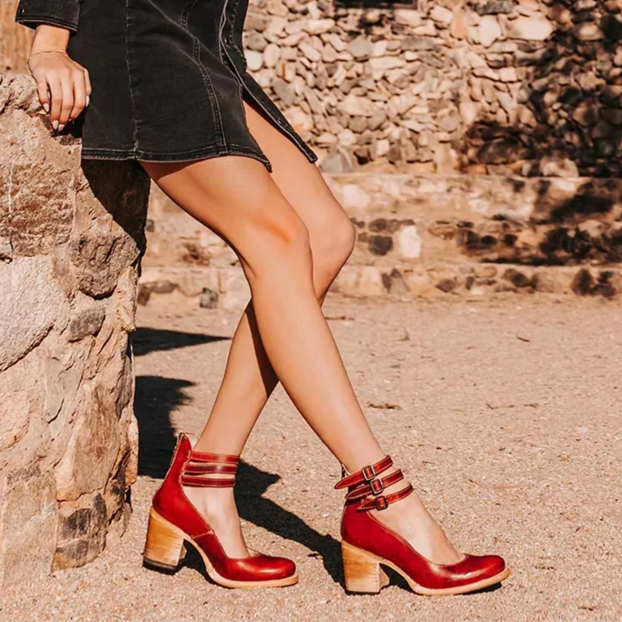 Red leather ankle-strap shoes with buckle, peep toe-style front, and block heel.