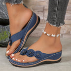 Women's wedge sandals in navy with flower straps, cushioned footbed, thong toe