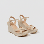Beige wedge sandals with T-strap, buckle, and textured platform sole