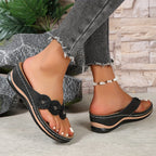 Women's wedge sandals in black with flower toe appliques and beaded ankle strap