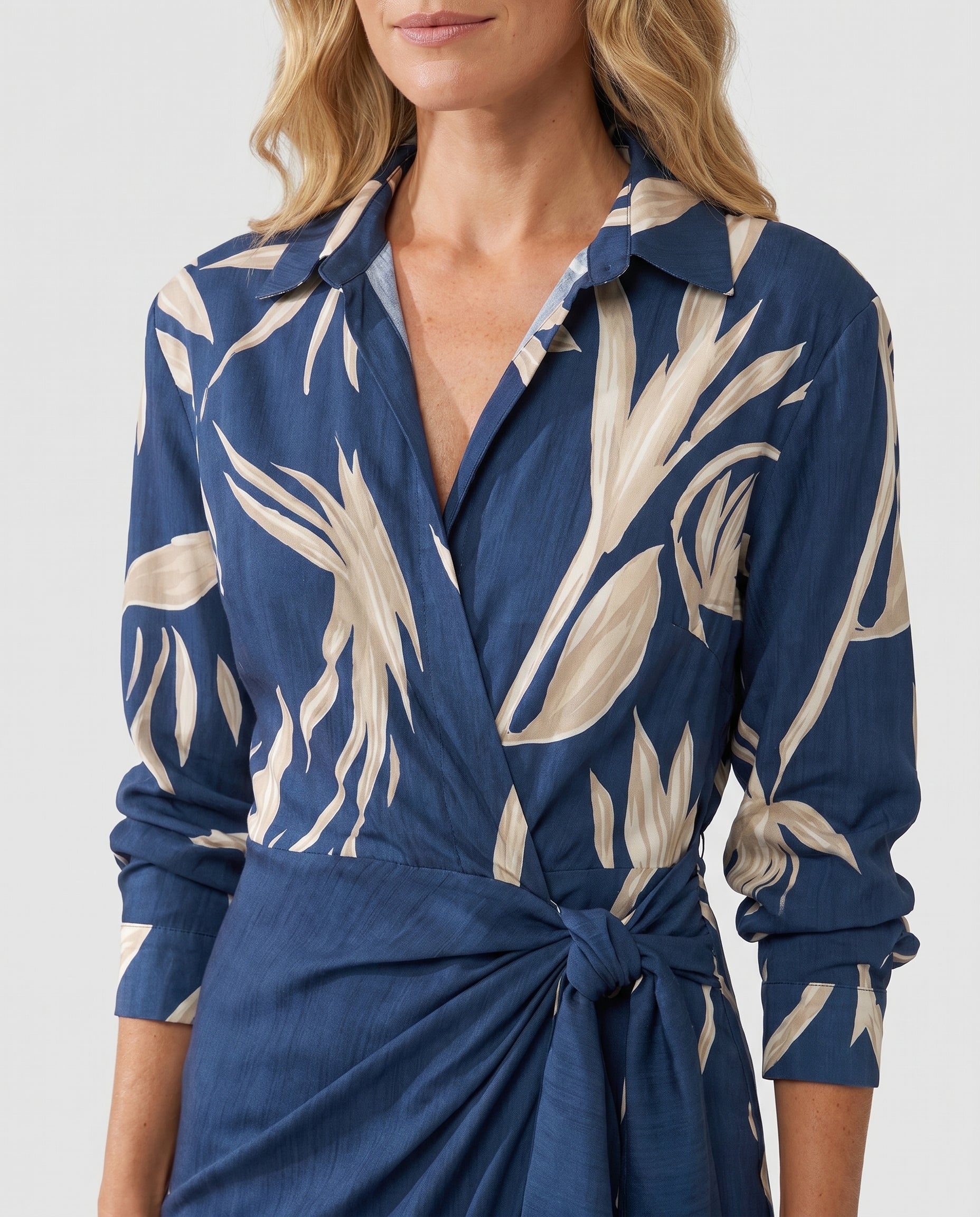 Blue leaf-print wrap dress close-up, V-neck, long sleeves, waist tie