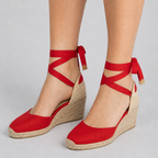 Red wedge espadrille sandals with crisscross ankle tie and jute wedge platform.