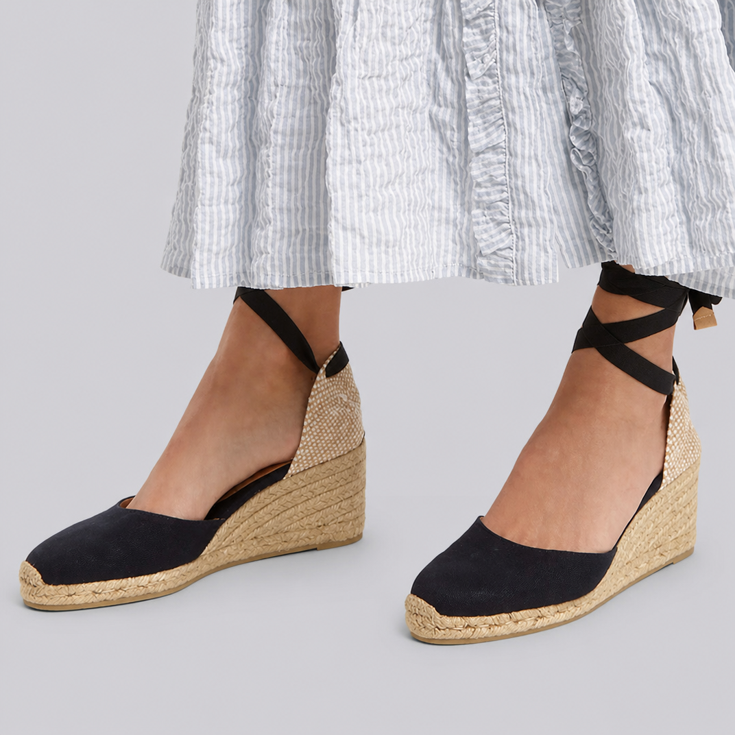 Black wedge espadrille sandals with ankle tie straps and jute wedge sole.