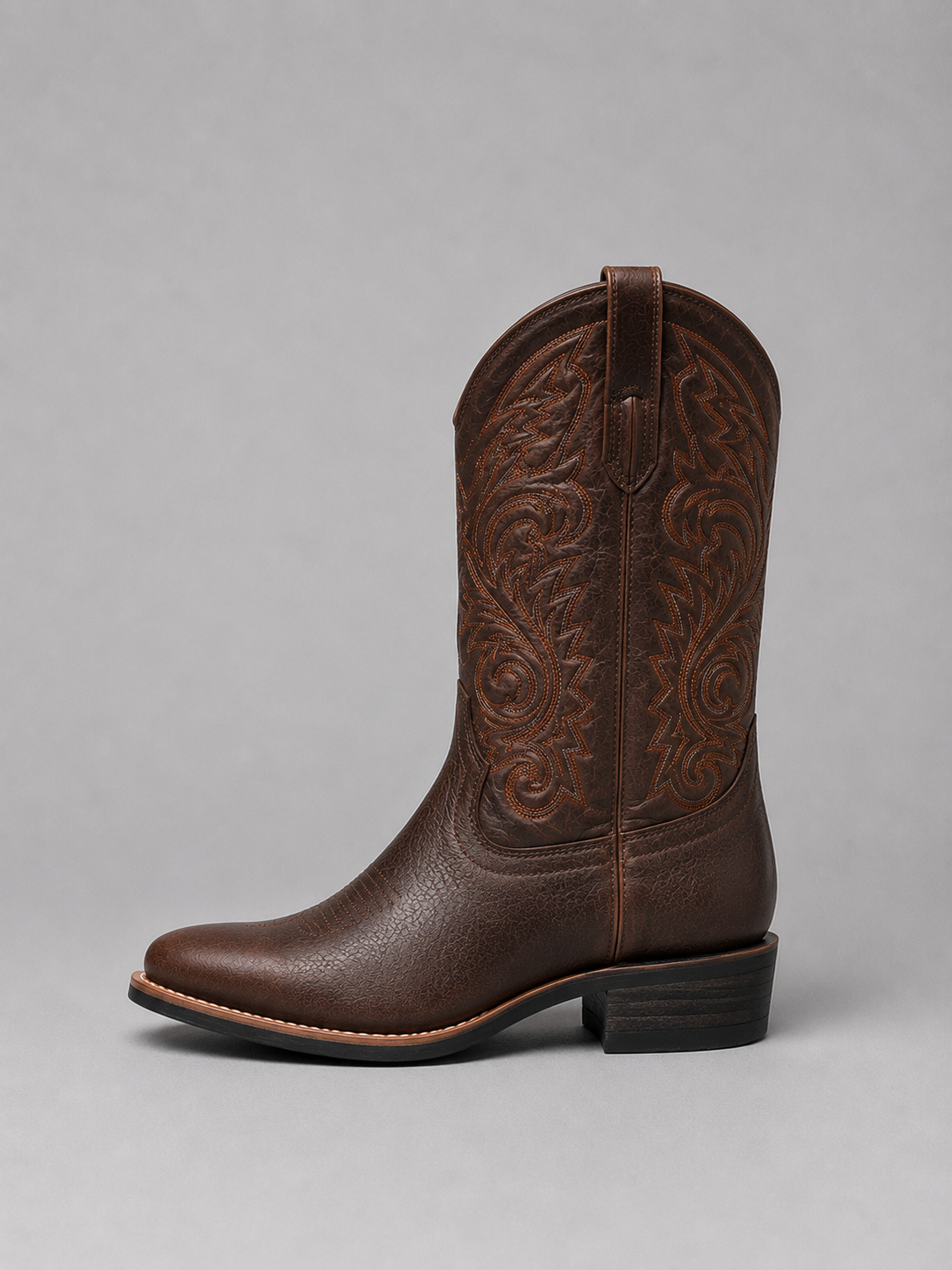 Brown leather cowboy boot with scrollwork embroidery and low block heel