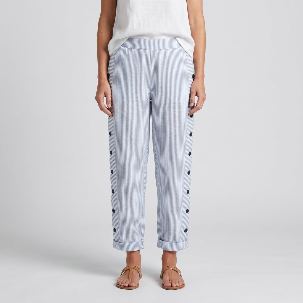Women’s blue striped trousers with button accents on both sides and cuffed hems