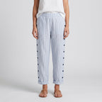 Women’s blue striped trousers with button accents on both sides and cuffed hems