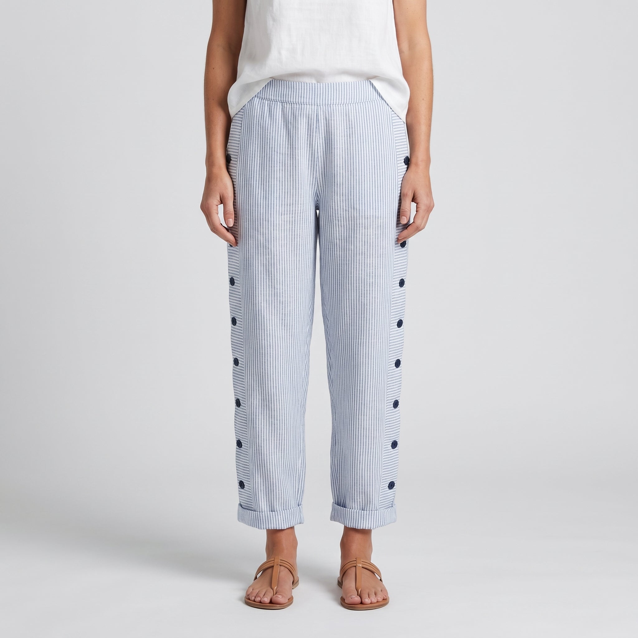 Women’s blue striped trousers with button accents on both sides and cuffed hems