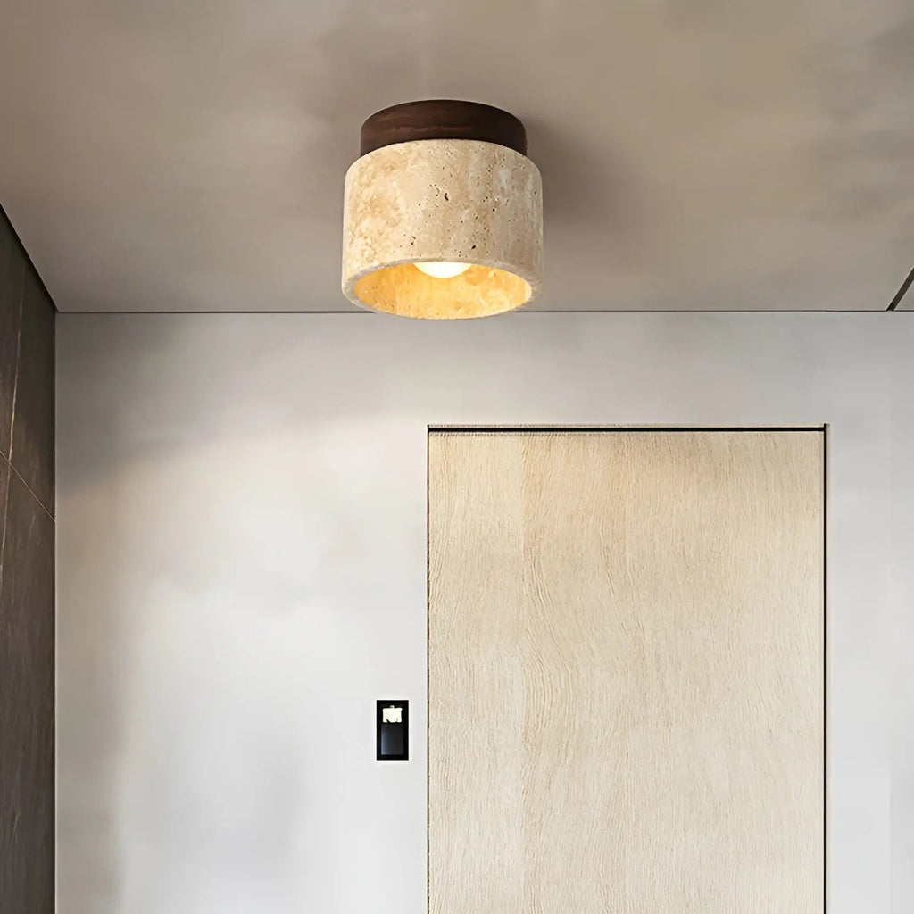 Flush mount ceiling lamp with round travertine shade and dark walnut wood top ring.