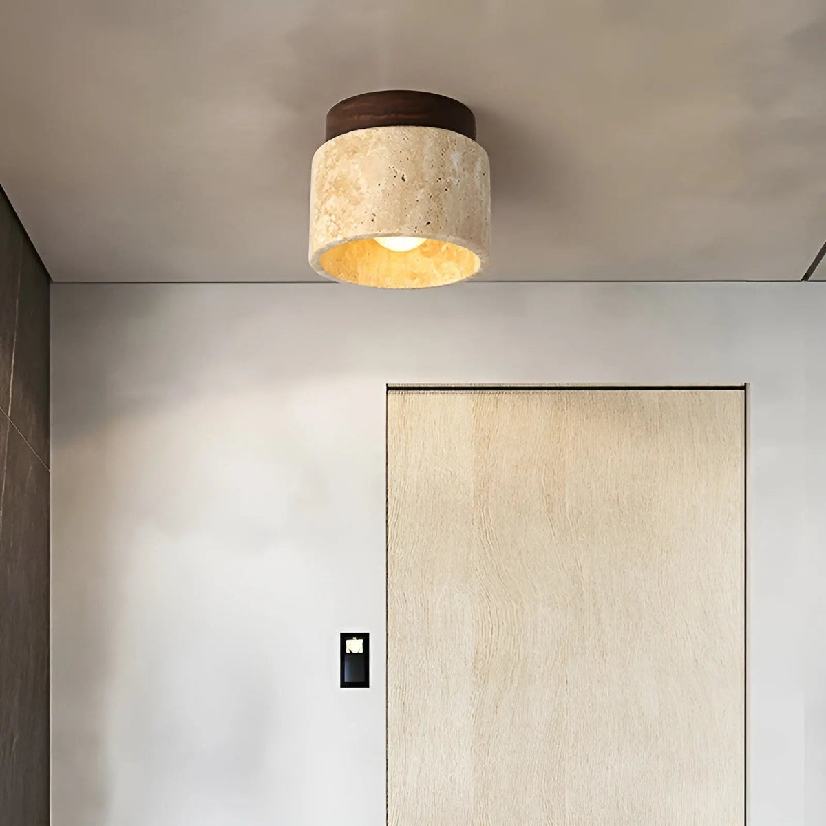 Flush mount ceiling lamp with round travertine shade and dark walnut wood top ring.